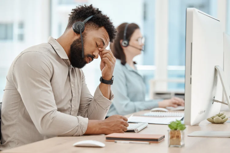 frustrated representative working at an auto warranty call center