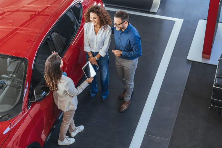 Young couple in a dealership buying a GM vehicle