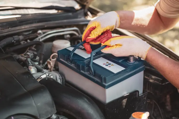 Battery being removed from a car