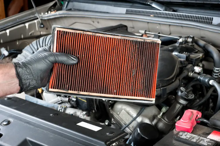 Image of a dirty orange car air filter
