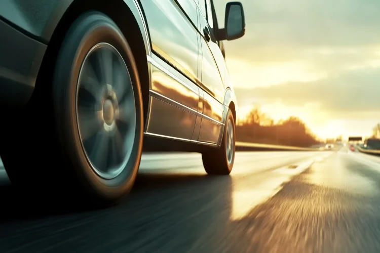 side view of a car with an exclusionary auto warranty speeding down the highway
