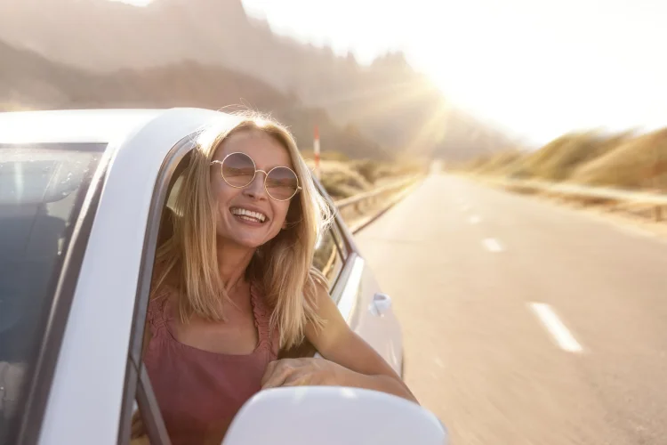 Happy female driver with an extended automobile warranty