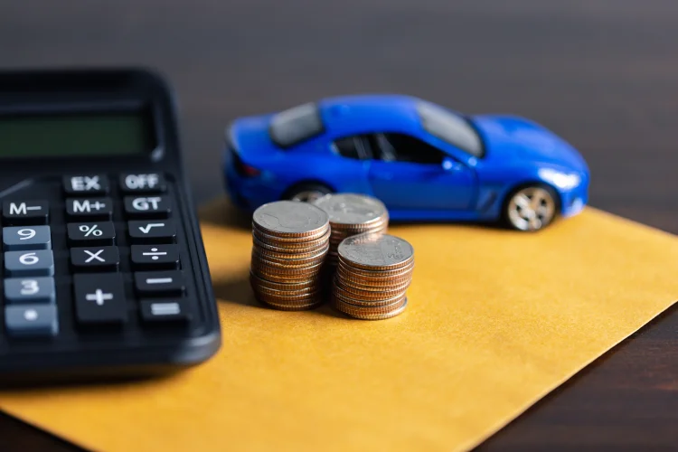 Picture of a blue toy car, calculator, and change representing an extended warranty cost estimate