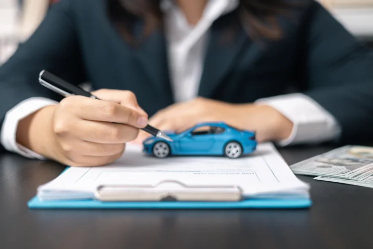 Photo illustration of lease buyout paperwork with an extended warranty bundled into the lease buyout financing