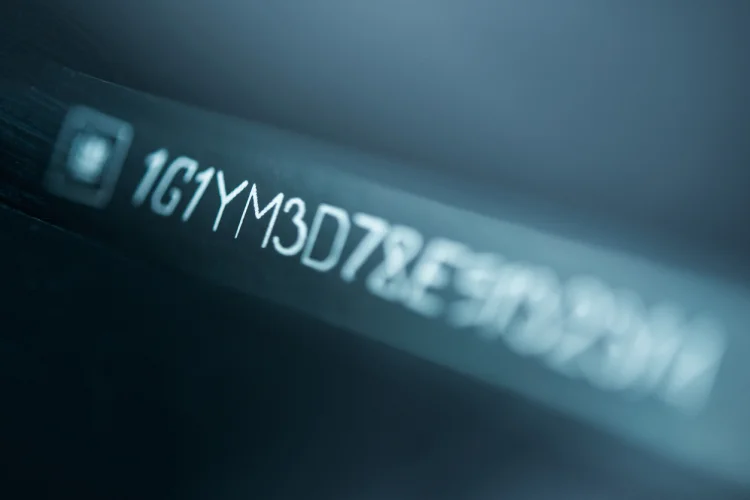 Closeup of a windshield plate with a vehicle identification number (vin)