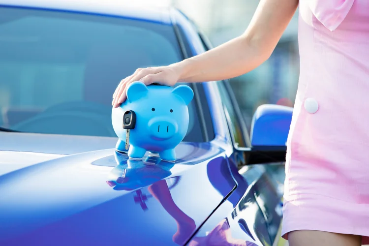 Blue piggy bank on top of a blue car
