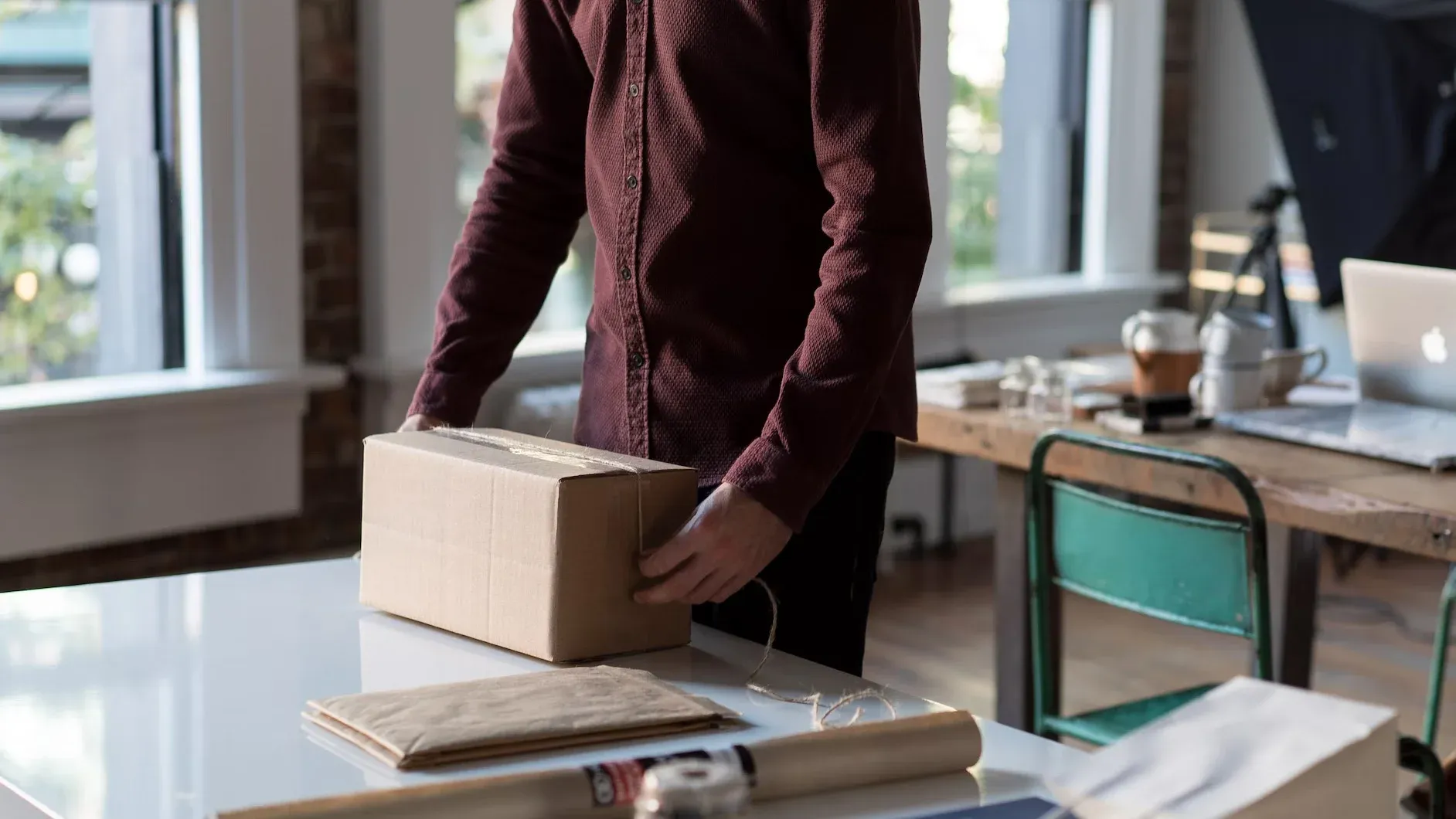 A person packaging a product in his office