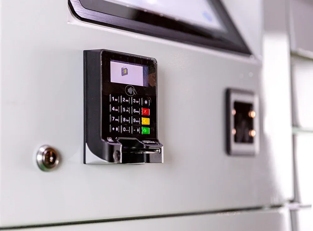 Close up of a credit card payment device mounted on a parcel locker