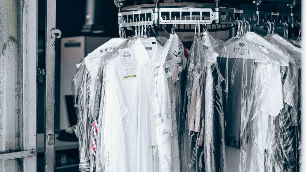 clothes on a rack at the dry cleaner