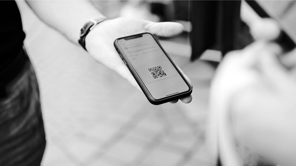 a man holding a phone with a qr code on the screen