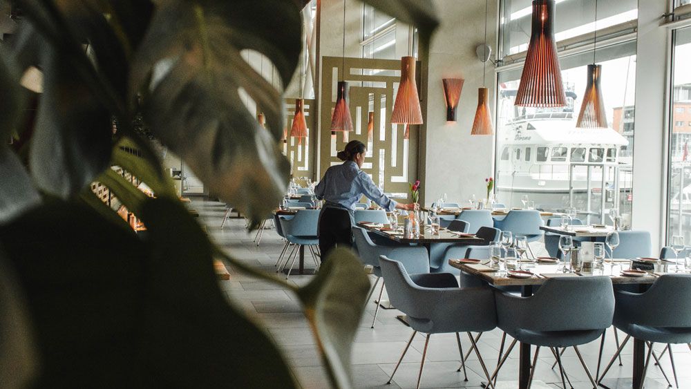 a waiter setting the table in a restaurant