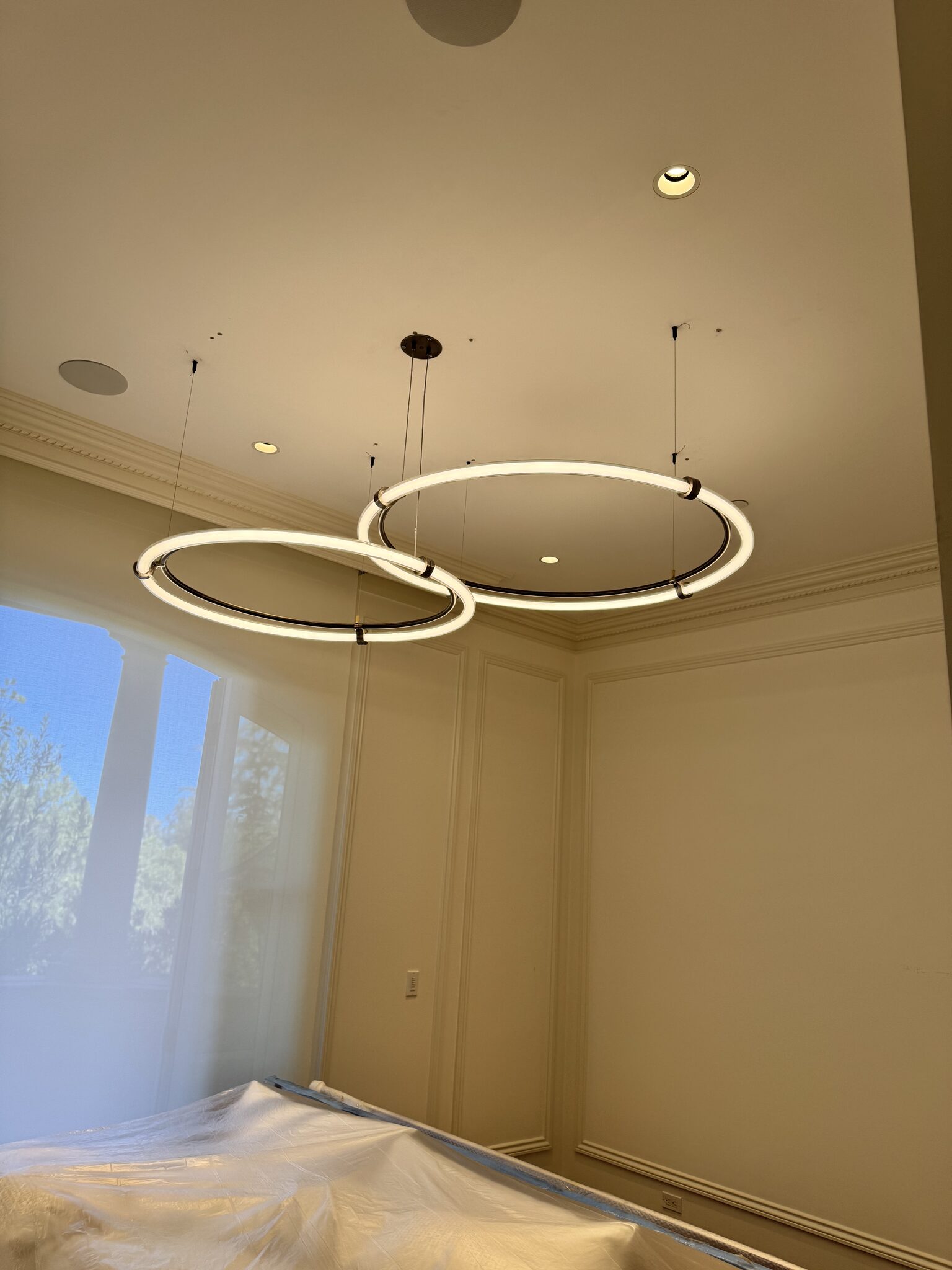 Twin ring pendant light installation in a formal room