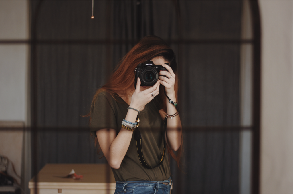 woman in green taking a photo