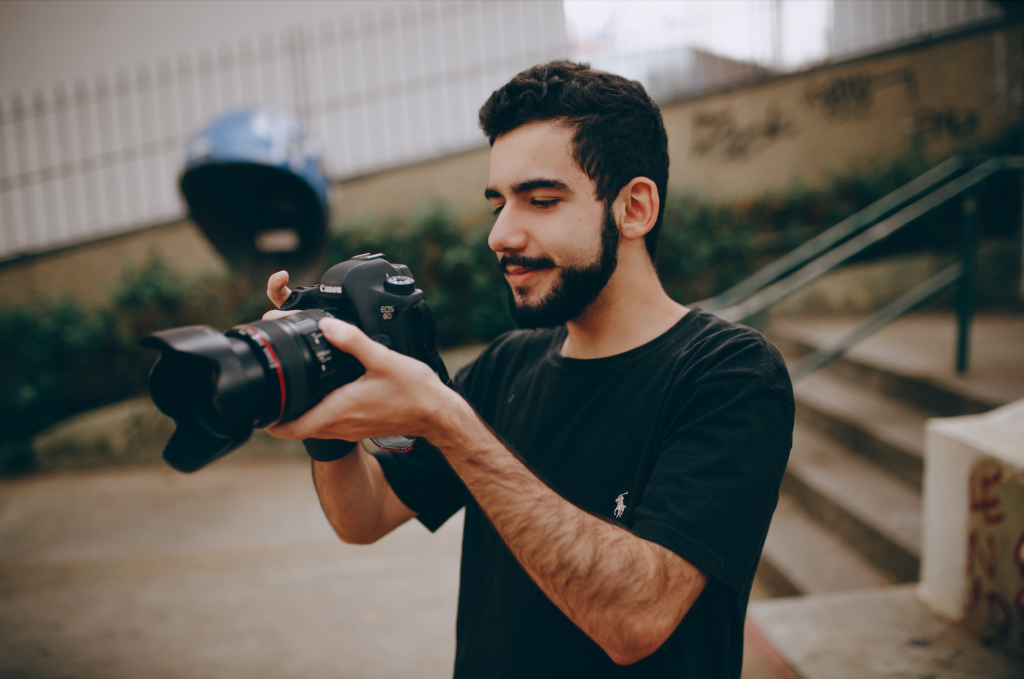 man in black taking a photo