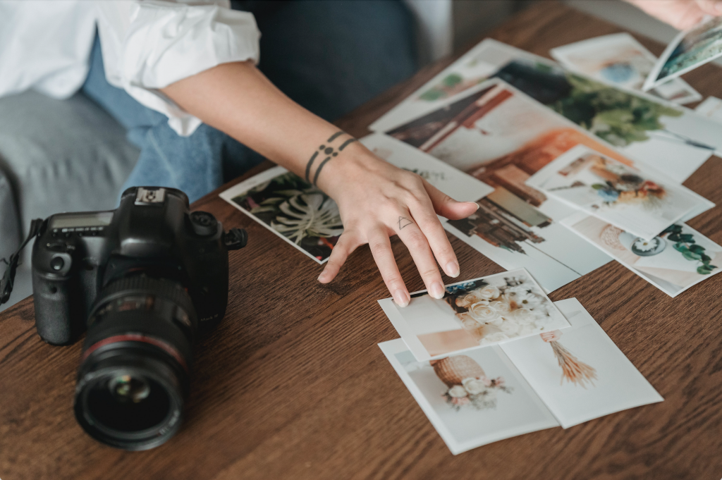 a hand picking photos with a camera on the side