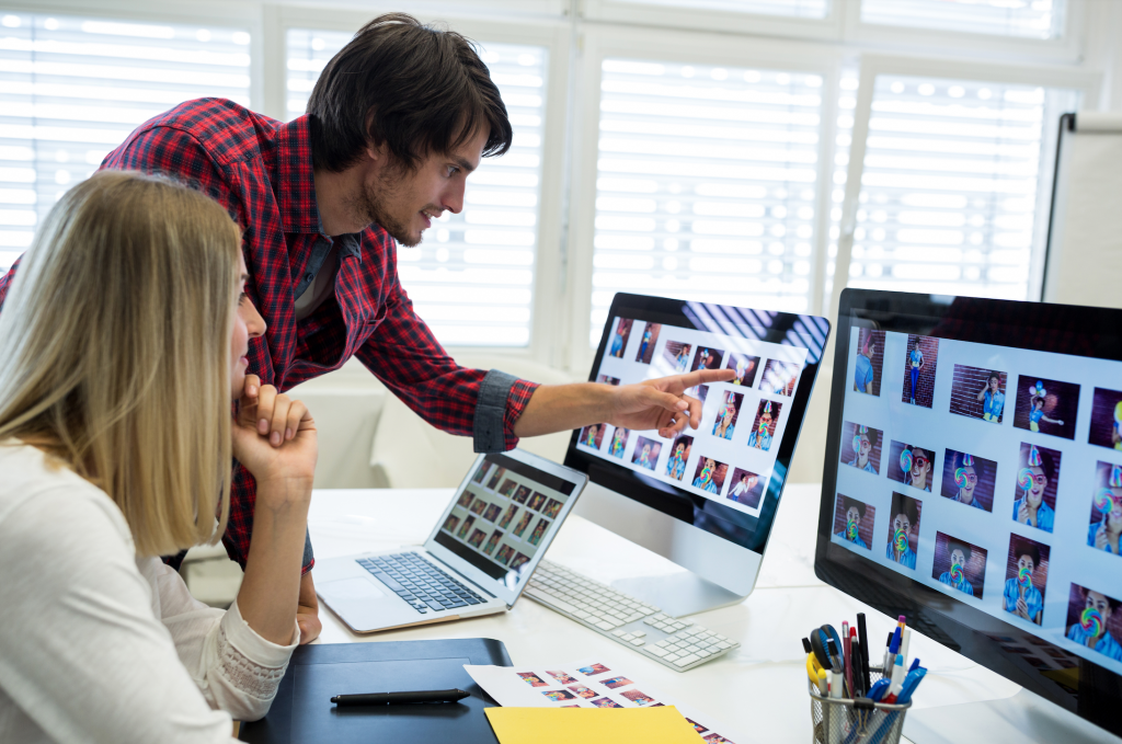 Man and woman culling photos in 3 different devices
