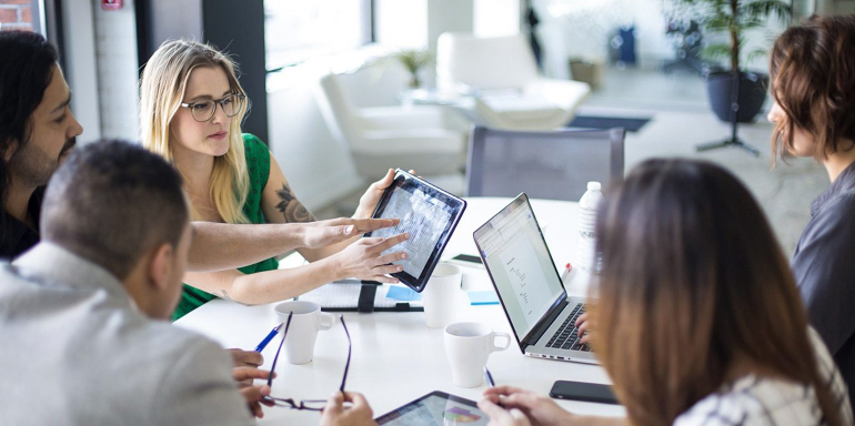 This picture shows a group of marketers determining the validity of their landing page A/B test.