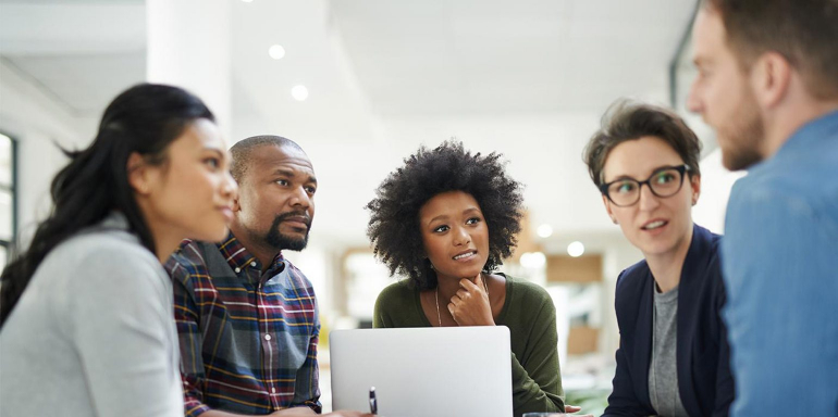 This picture shows a VP of Marketing talking with his team explaining how to use their new collaboration software and become more efficient.