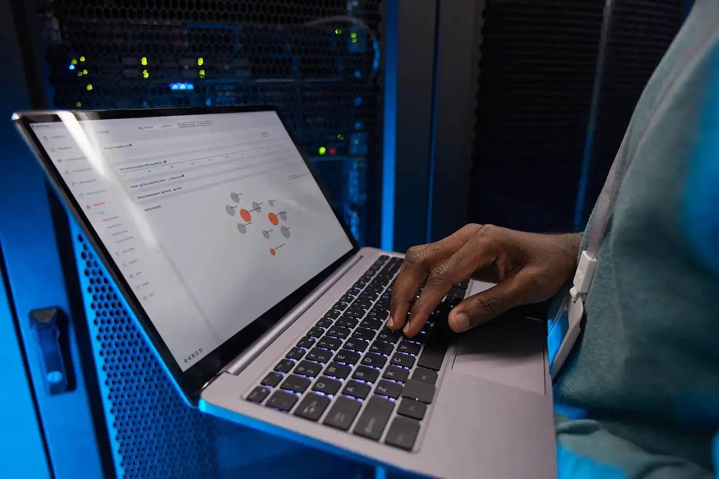 ExeonTrace - Young man in server room with laptop screen (1).webp