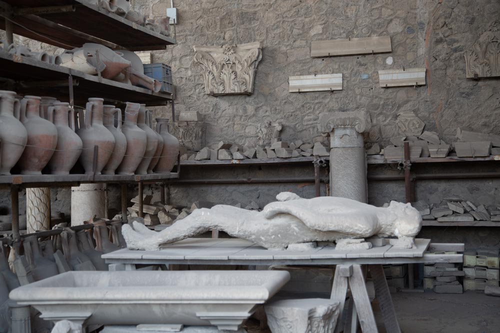 Italy, Pompeii, store-room with various bowls, amphorae, and Plaster casts of victims