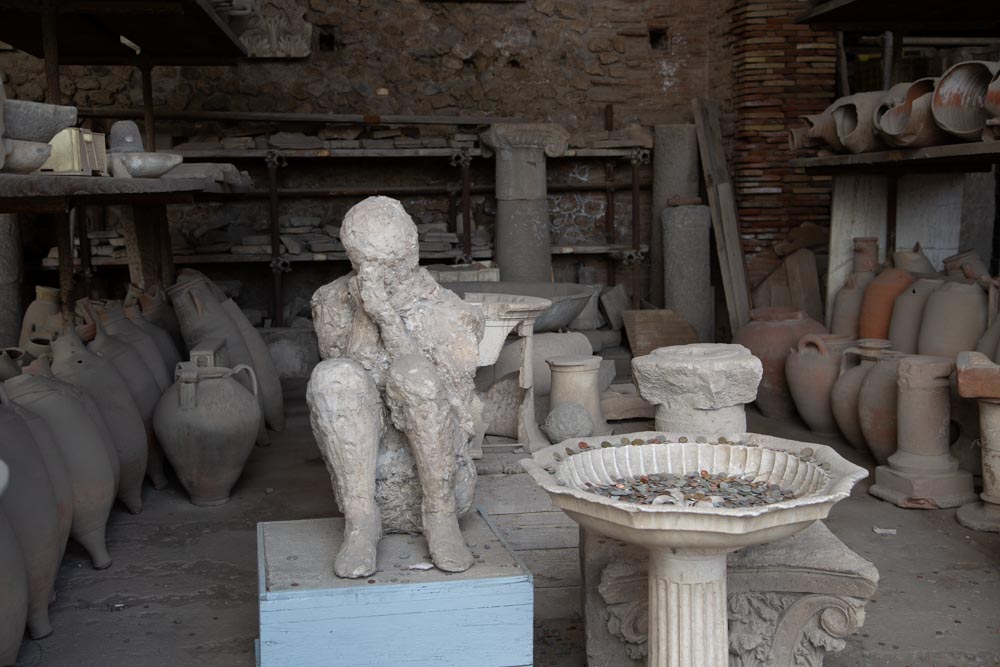 Italy, Pompeii, store-room with various bowls, amphorae, and Plaster casts of victims2