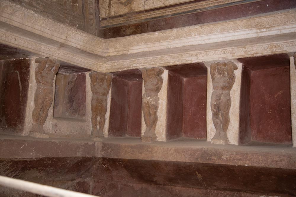 Italy, Pompeii,Forum Baths, view of the Tapidaruim with coloured stucco and shelves separated by telamones2