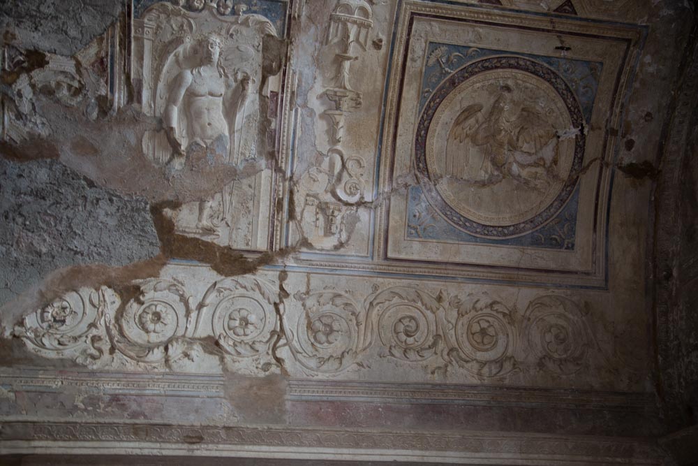 Italy, Pompeii,Forum Baths, view of the Tapidaruim with coloured stucco and shelves separated by telamones3
