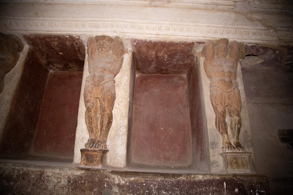 Italy, Pompeii,Forum Baths, view of the Tapidaruim with coloured stucco and shelves separated by telamones4