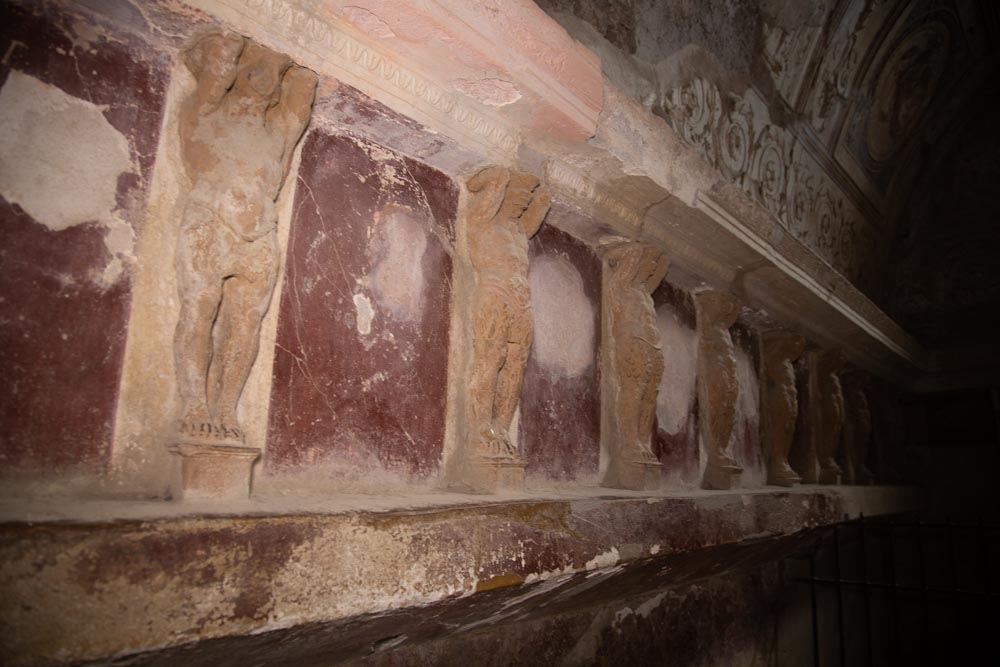 Italy, Pompeii,Forum Baths, view of the Tapidaruim with coloured stucco and shelves separated by telamones5