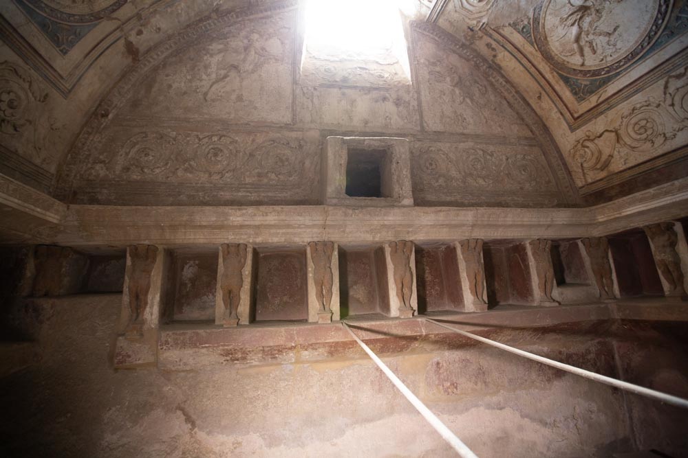 Italy, Pompeii,Forum Baths, view of the Tapidaruim with coloured stucco and shelves separated by telamones13
