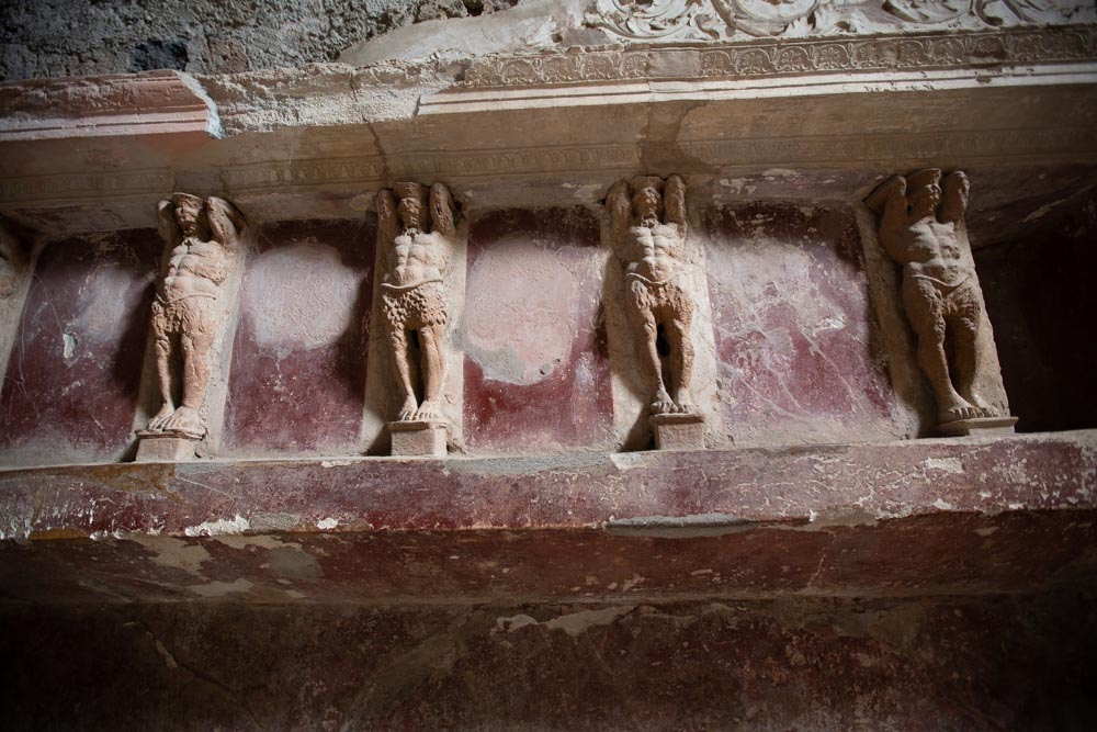 Italy, Pompeii,Forum Baths, view of the Tapidaruim with coloured stucco and shelves separated by telamones17