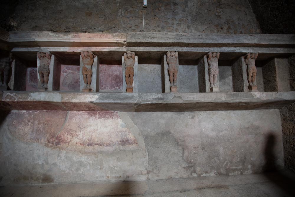 Italy, Pompeii,Forum Baths, view of the Tapidaruim with coloured stucco and shelves separated by telamones19