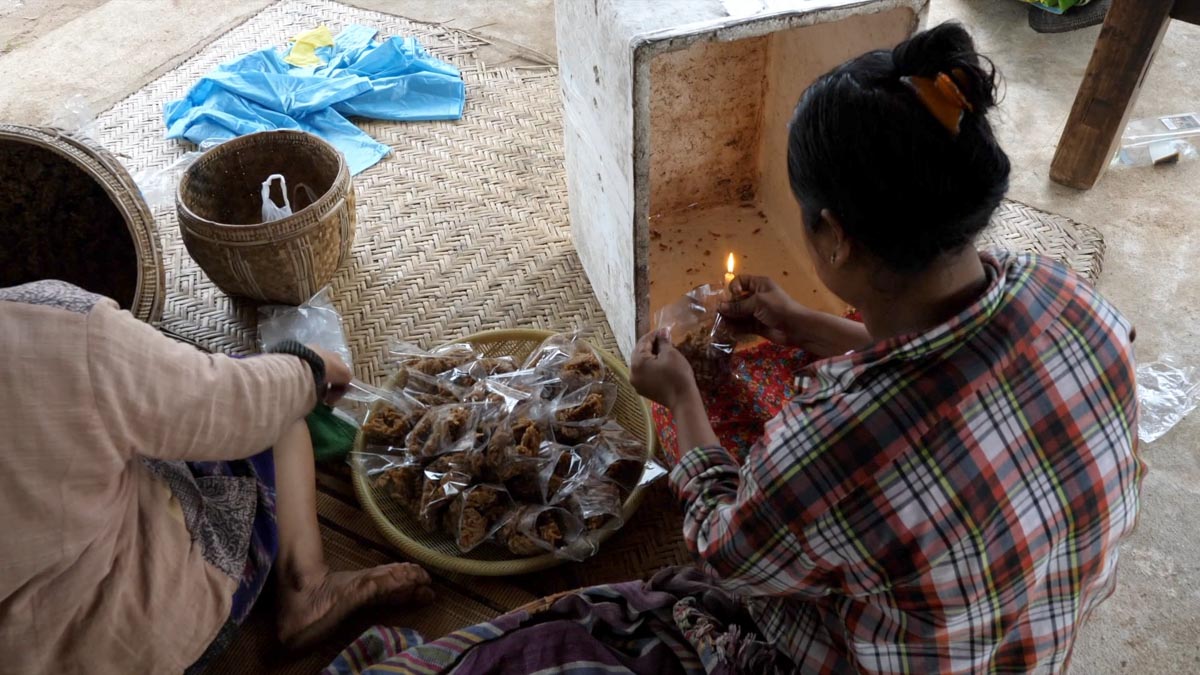 Myanmar, traditional - Packaging of snacks from plam sugar, ginger and coconuts sweet