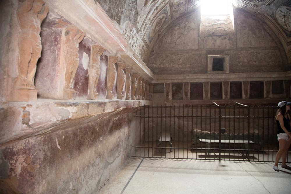 Italy, Pompeii, Forum Baths, view of the Tapidaruim with coloured stucco and shelves separated by telamones