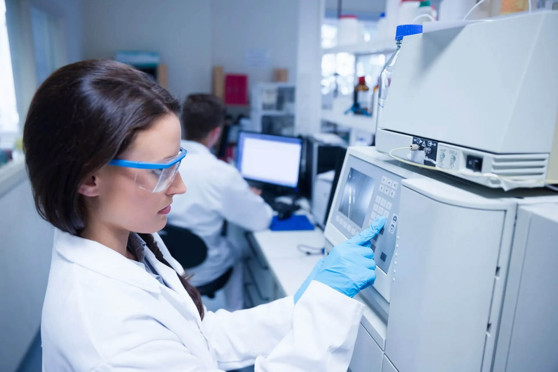 Laboratory technician operating medical equipment