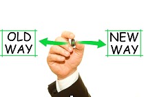 Old way vs. new way – a man pointing from the old way sign to the new way sign