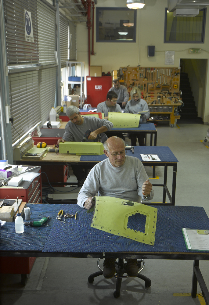 Technician working on a pod in the assembly hall