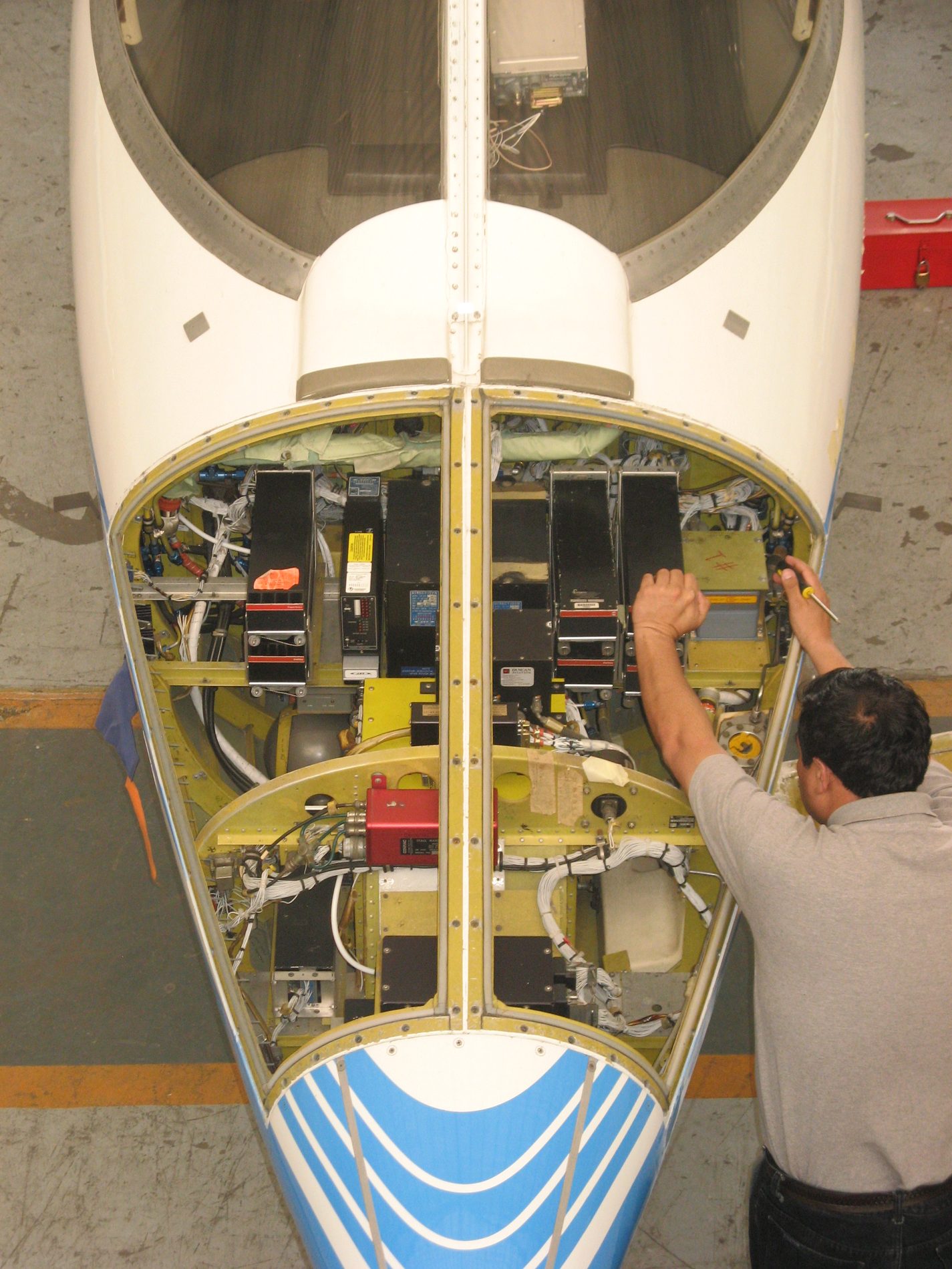 Technician wiring a new avionics bay