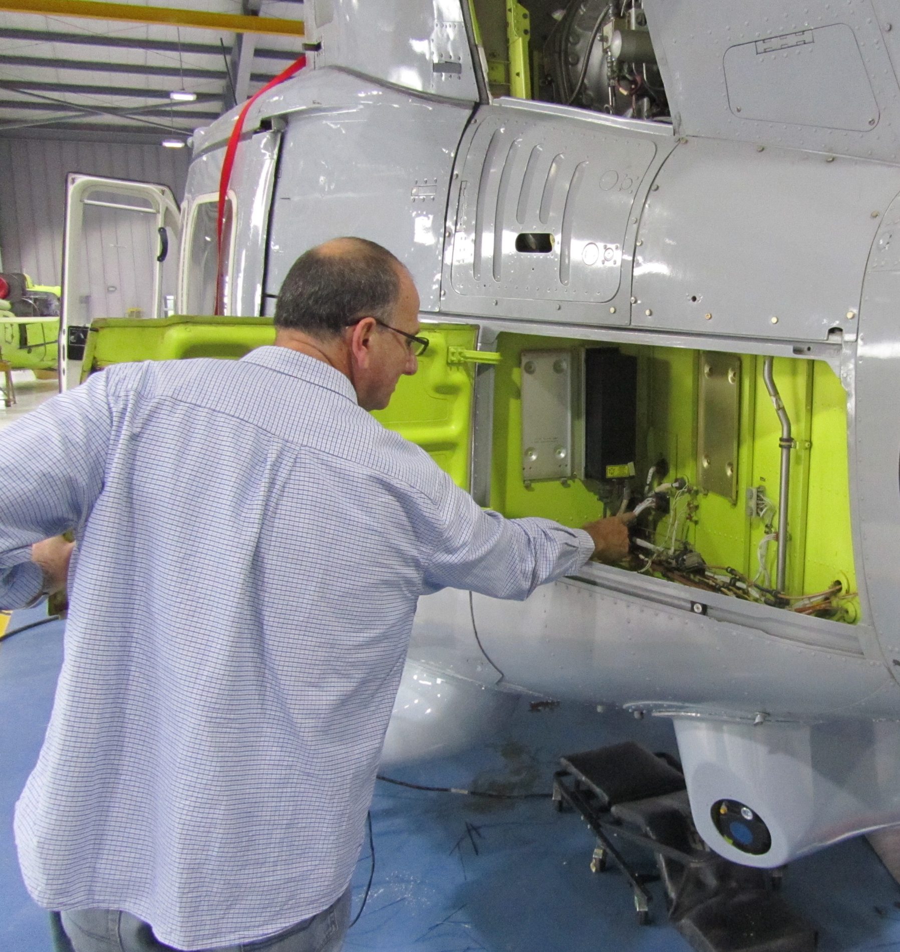 Engineer fitting an upgraded system on the airframe