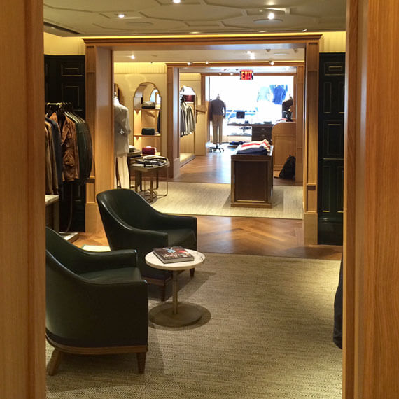 Shop interior showing full length of store with wooden floor and entry frames.