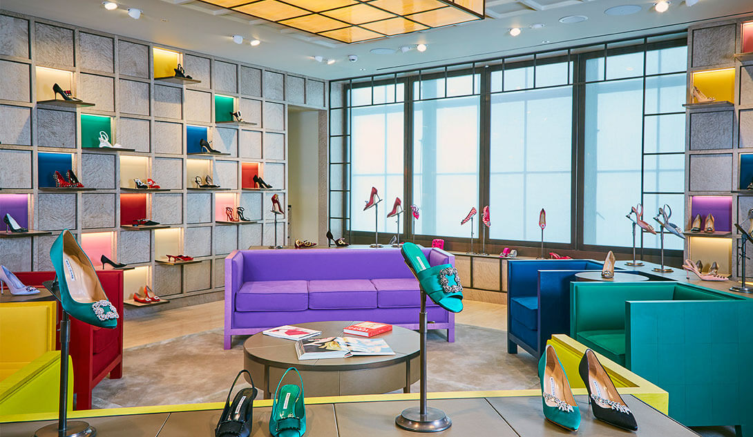 Malono Blahnik store interior, showing coloured display wall and seating area