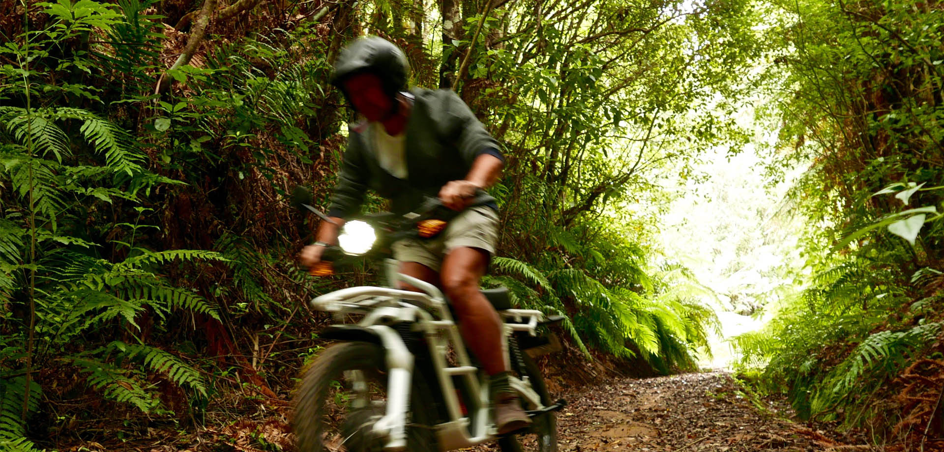 Rider on a Motubikes electric motorbike on a Great Barrier Island forest road