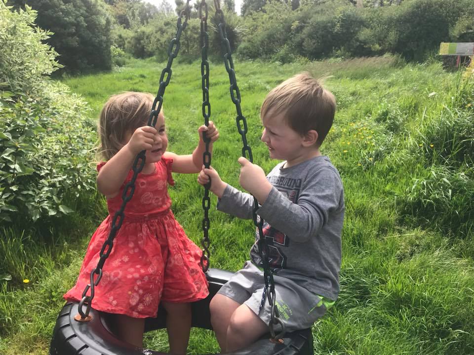 Two children on a swing