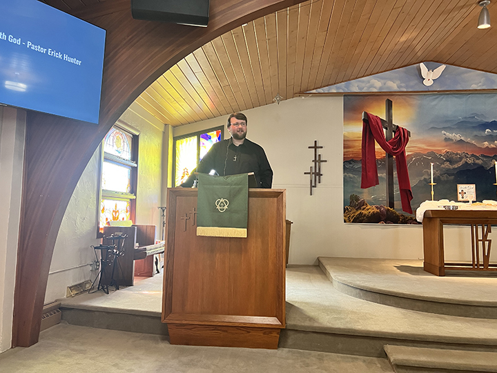 Pastor Erick Hunter leading worship in the sanctuary