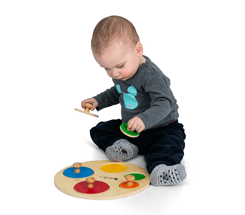 A child playing with a Doron Layeled wooden game