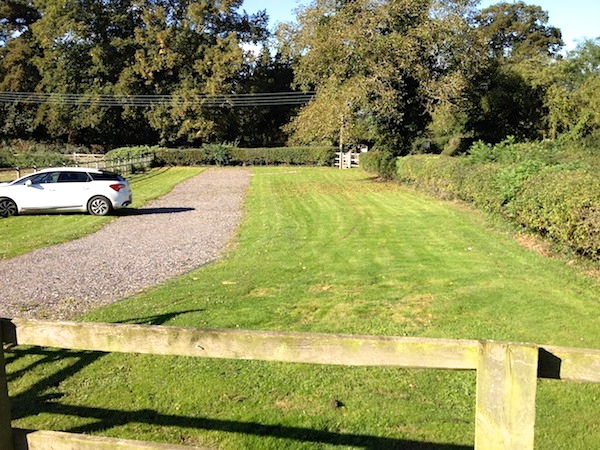 The overflow car park is underlaid with 'grass reinforcement protection' mesh. The car park also leads to the adjacent church.