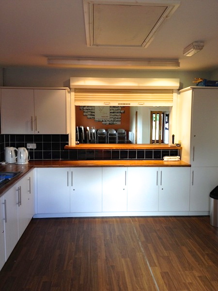 Kitchen and bar servery share the same opening, the kitchen is fitted with an electric double oven and 'Calor' gas hob.