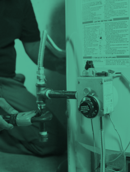 A plumber installing a water heater