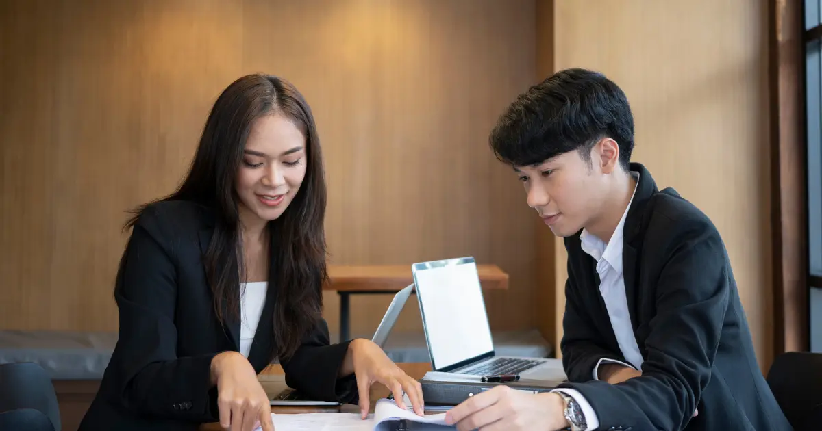 a professional working on a laptop, symbolising the role of double taxation agreements in international hiring and remote workforce management.
