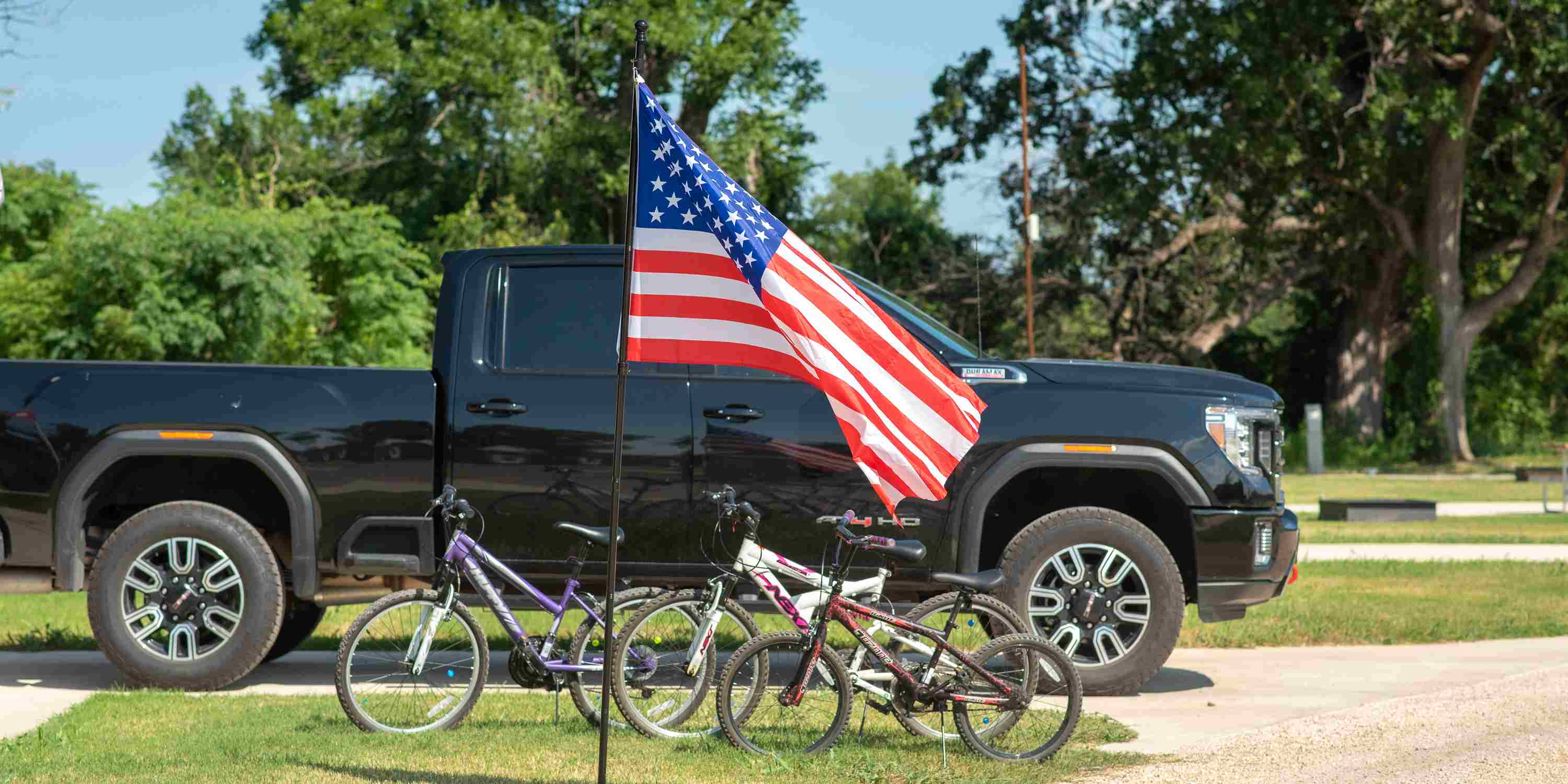 An American flag waving in the wind at an RV site at Camp Fimfo Waco